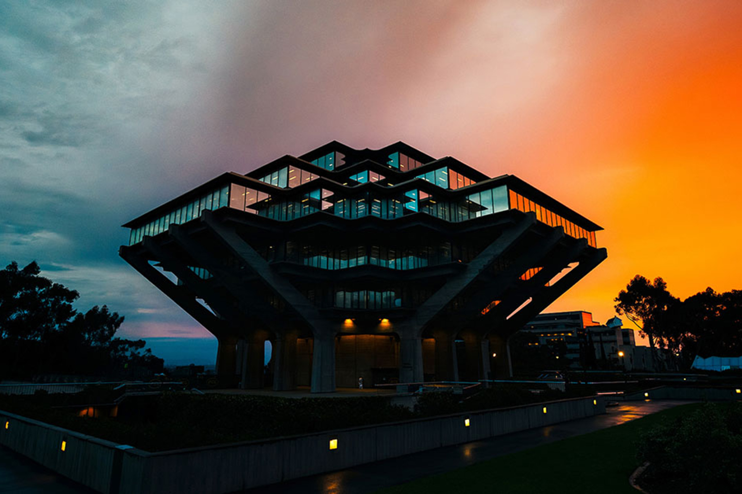 Geisel Library exterior against blue and orange skies